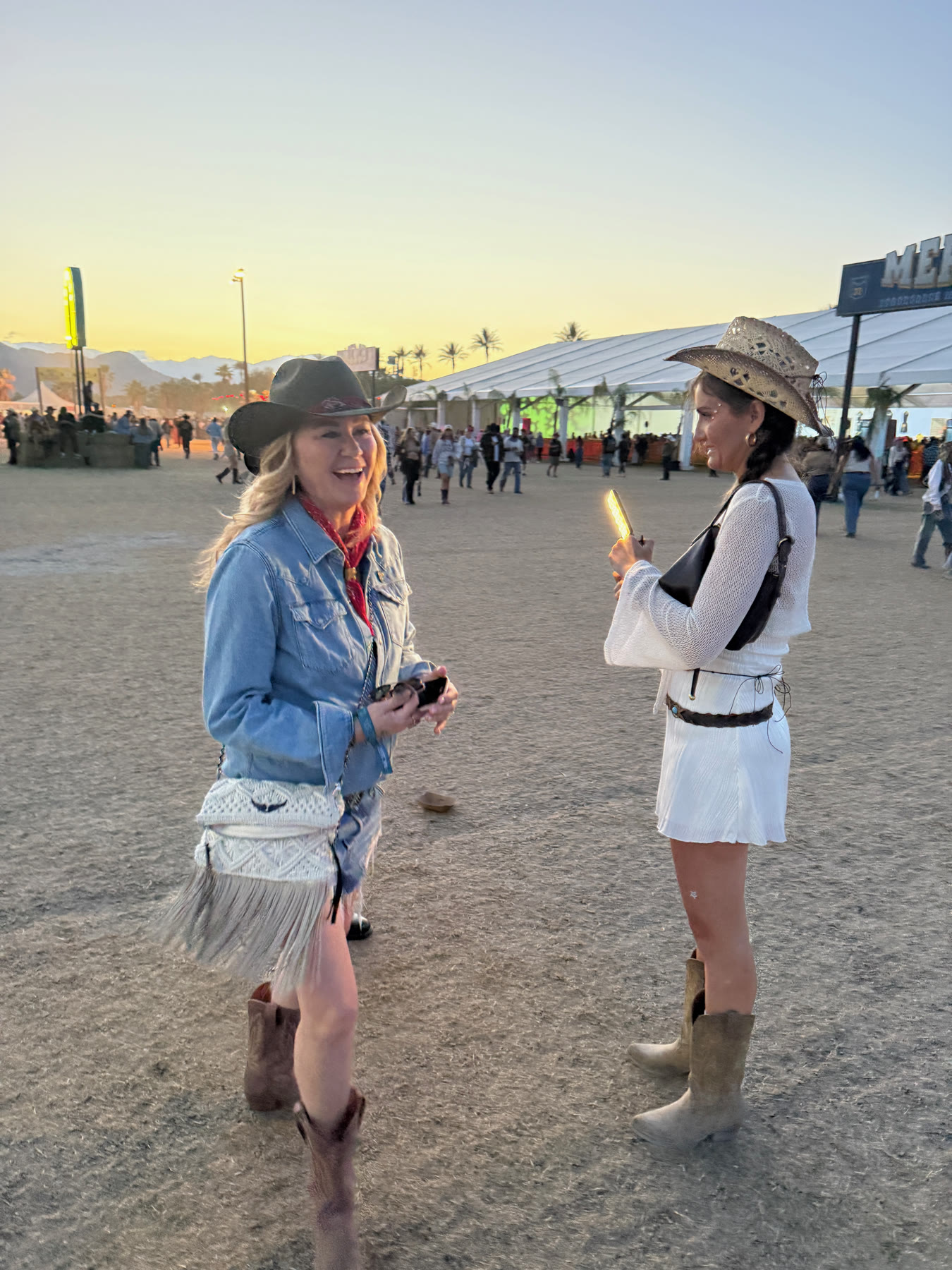 three founding members in hats and boots on the polo field at sunset